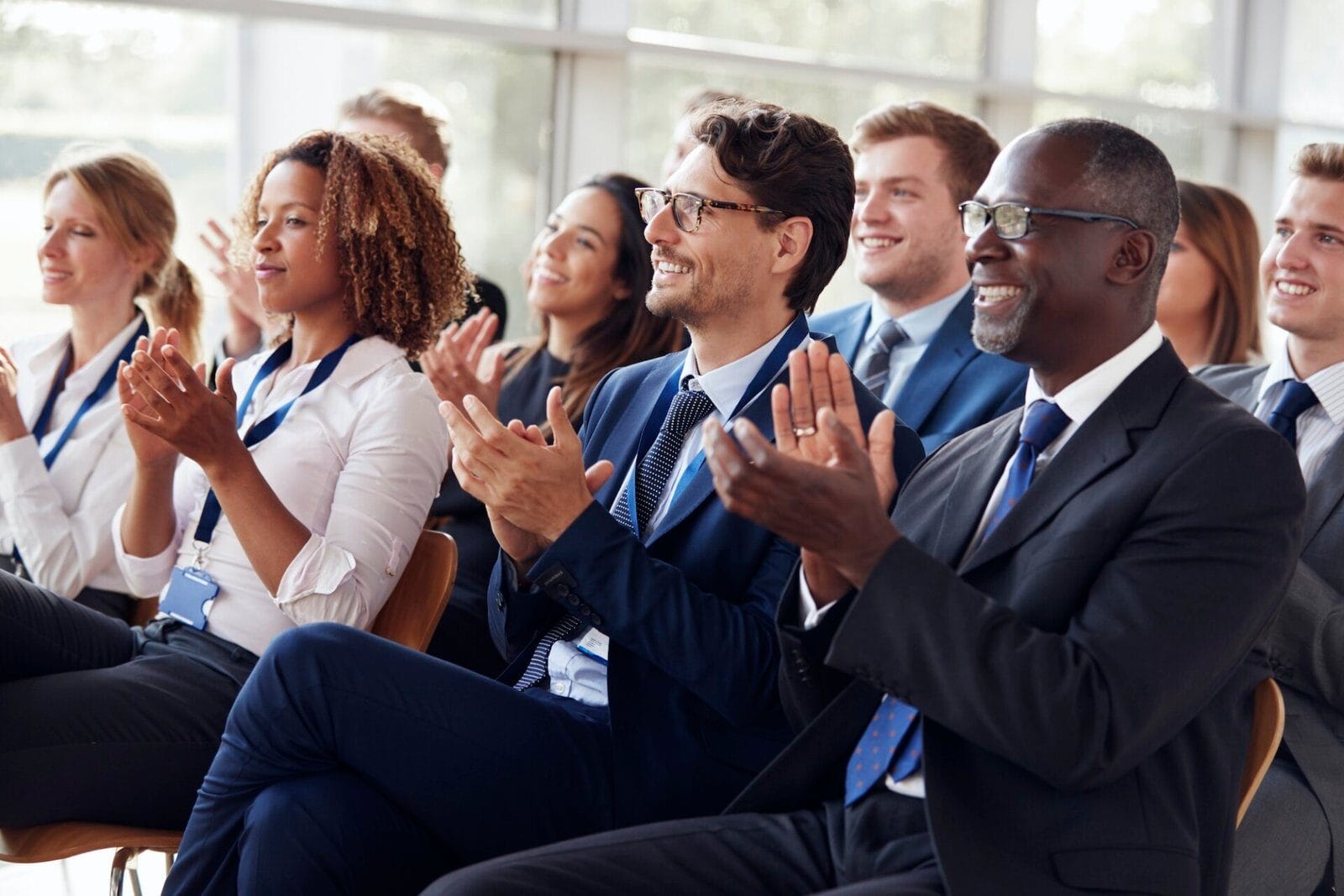 Delegates applauding in a conference audience