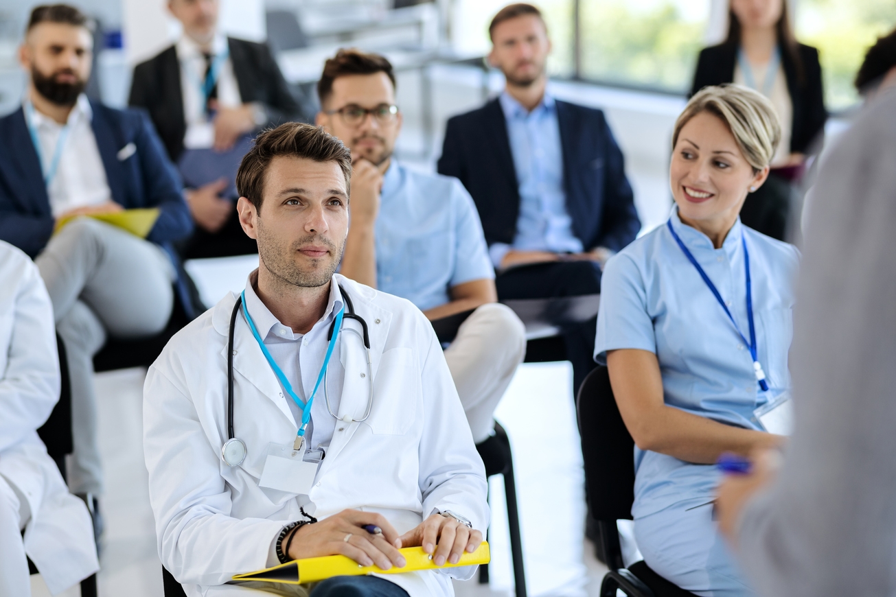 Healthcare professionals and industry delegates in a conference audience